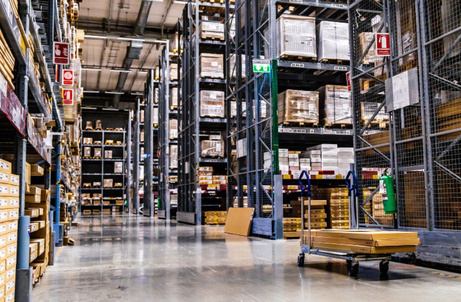 A warehouse trolley with optimal castors being used within a warehouse.